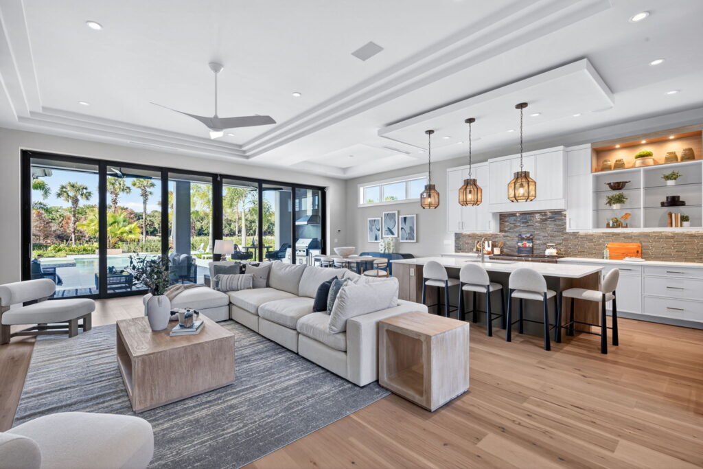Alt Text: Professionally staged luxury living room at 19062 Via Messina Way featuring warm neutral furnishings, layered textures, and an inviting open-concept layout. 
